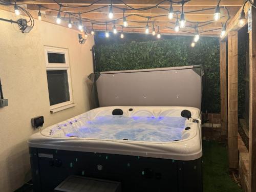 a jacuzzi tub in a backyard with lights at The Wootton House in Doncaster