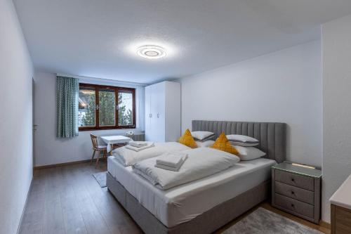 a bedroom with a large bed and a table at Appartement Tschol in Flirsch