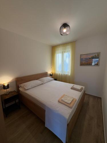 a bedroom with a large bed and a window at Luxury Apartment The Best in Cavtat