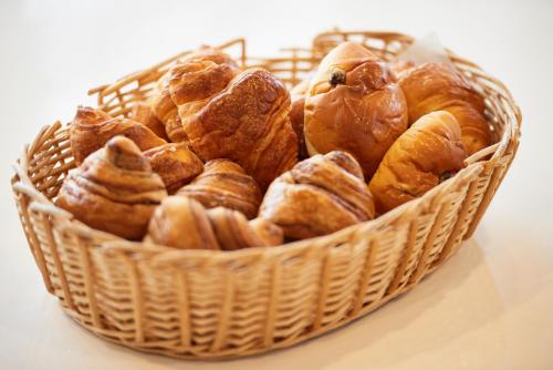 a basket filled with croissants on a table at Hotel Select Inn Aomori in Aomori