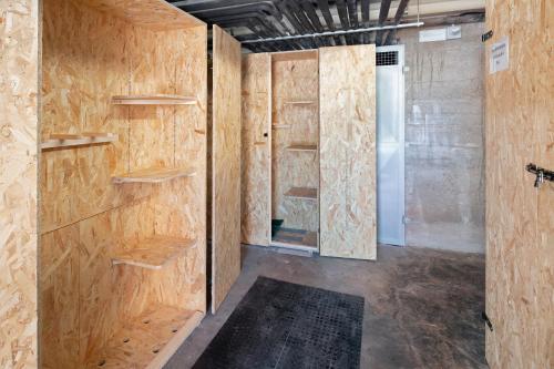 a room with wooden walls and a closet at Appartamenti Lella in Vigo di Fassa