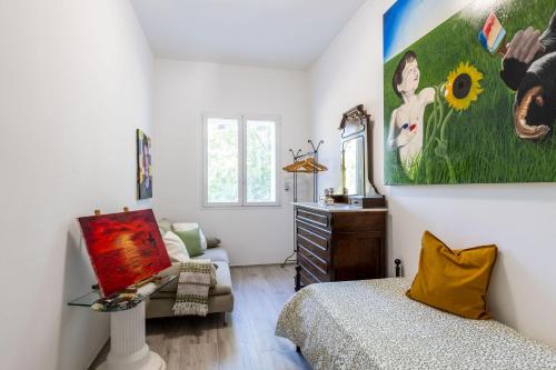 a bedroom with a bed and a painting on the wall at Italian Experience-Art&Sea House in Fano