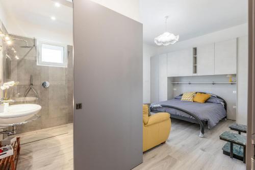 a bedroom with a bed and a sink and a mirror at Italian Experience-Art&Sea House in Fano