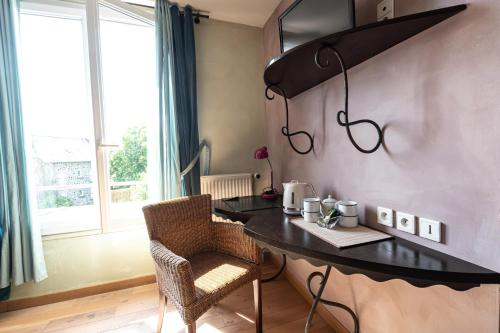 a kitchen with a table and chairs in a room at Beauséjour in Calvinet