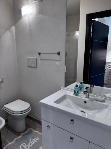 a white bathroom with a toilet and a sink at Gabici Suite Ravenna in Ravenna