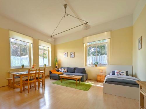 a living room with a bed and a couch and a table at Ferienwohnung Barbarossa - Holly in Rottleben