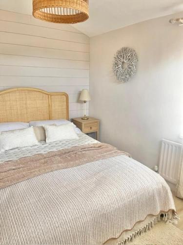 a bedroom with a bed and a table with a lamp at Alder House Lytham in Lytham St Annes