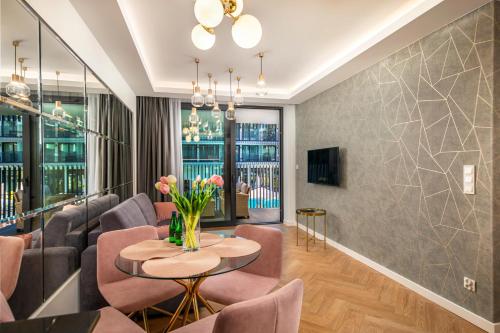 a living room with a table and chairs at Apartament Bursztynowa Komnata 116 Stegna nad morzem in Stegna