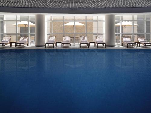 a group of chairs sitting in a pool in a building at Movenpick Hotel Qassim in Buraydah