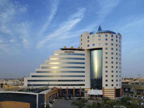 a hotel with a large building in a city at Movenpick Hotel Qassim in Buraydah