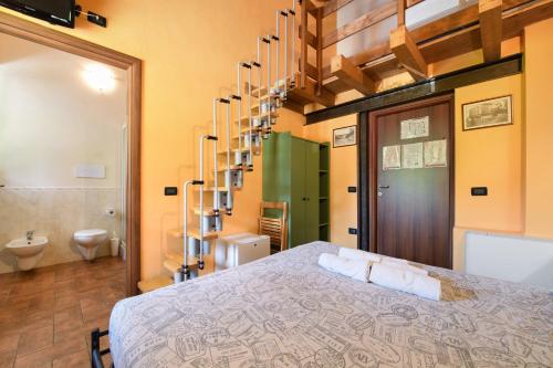 a bedroom with a large bed and a bathroom at Agriturismo El Giardì in Marone