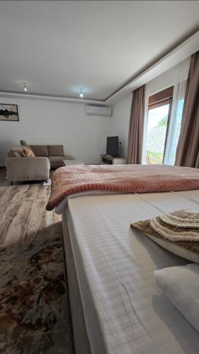 a bedroom with a large bed with a window at Lux studio - Vrh Đevojka in Borje