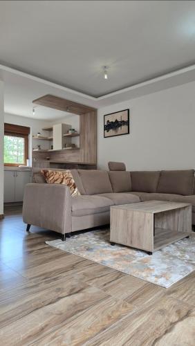 a living room with a couch and a coffee table at Lux studio - Vrh Đevojka in Borje