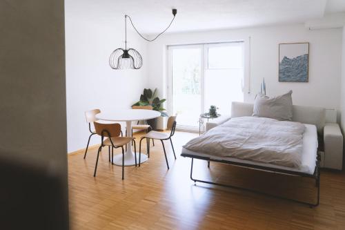 a bedroom with a bed and a table and chairs at Apartment 39 in Giengen an der Brenz