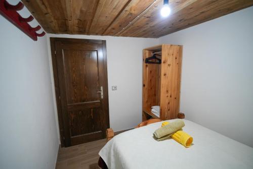 a bedroom with a bed with two towels on it at Kulla e Sadri Lukes in Theth