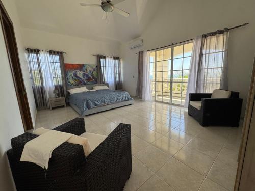 a living room with a bed and a couch at Villa La Dueña in San Felipe de Puerto Plata