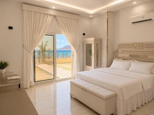 a bedroom with a bed and a view of the ocean at Nuweiba house camp in Nuweiba
