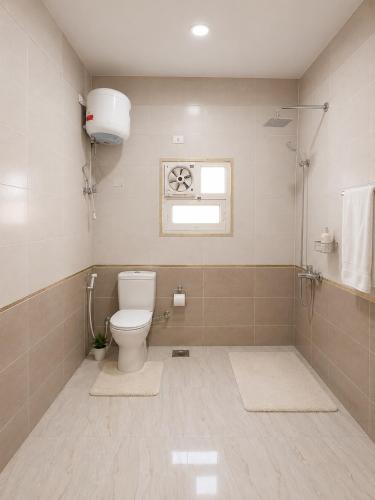 a bathroom with a toilet and a window at Nuweiba house camp in Nuweiba