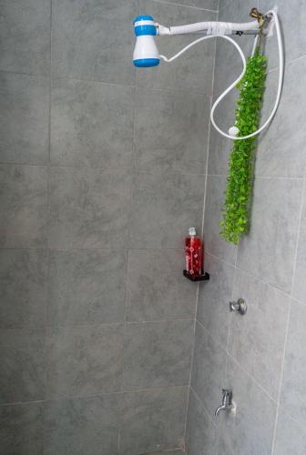 a shower with a blue light in a bathroom at Stylish 10th Floor Studio with great Views ,Fast Wi-Fi and Secure in Nairobi