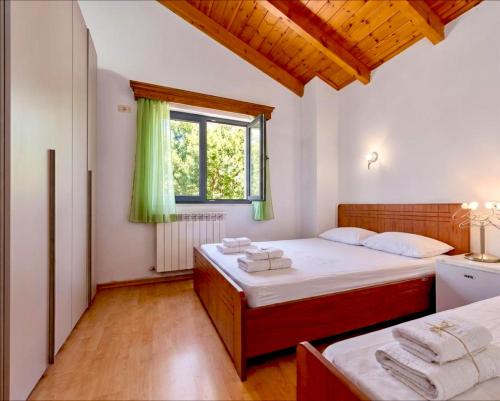 a bedroom with a bed and a window at Countryside Villa in Vlorë