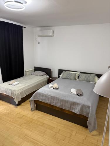 a bedroom with two beds and a lamp at Motel Victoria in Zvornik