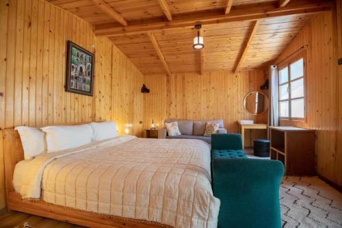 a bedroom with a bed in a wooden room at Dar l'eau Vive in Bine el Ouidane