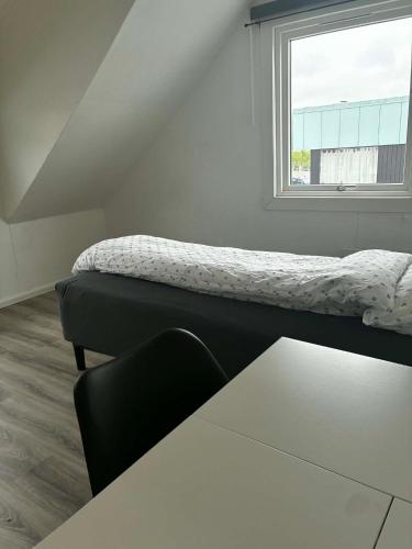 a room with two beds and a window at Bedify Lodge Sokndal in Sokndal
