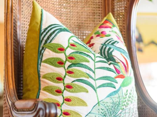 two pillows on a chair in front of a mirror at Nakai Beach Homestay in Trafalgar