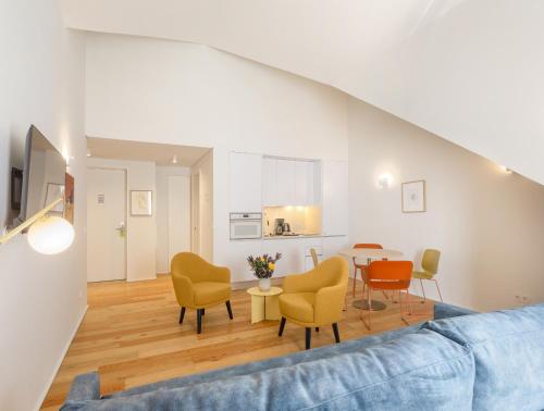 a living room with a couch and chairs and a table at LSA Estrela by Numa in Lisbon