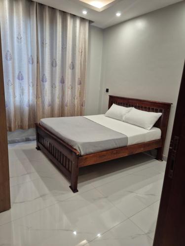 a bedroom with a bed in a room at CozyStay Homes in Kampala