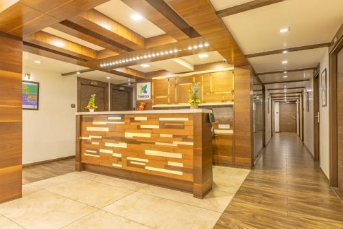 a lobby of a building with a reception counter at Treebo Aaram Orchard in Ahmedabad