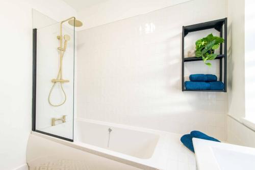 a white bathroom with a tub and a mirror at Central Sheffield Stay, Work Trips, Contractors & City Breaks in Sheffield