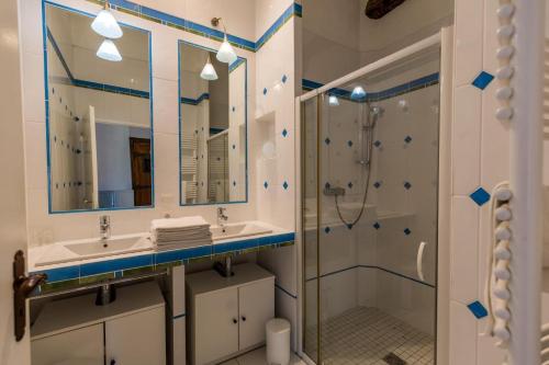 a bathroom with two sinks and a shower at La tour du guet in Arouille
