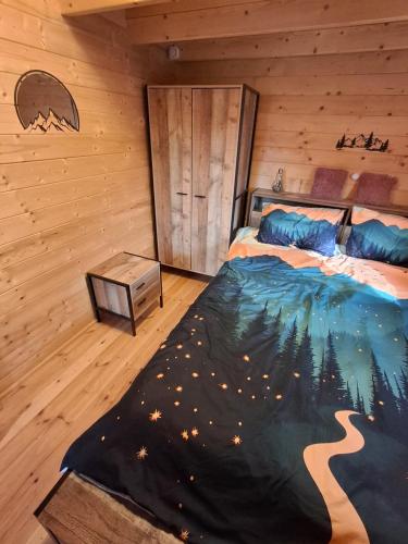 a bedroom with a bed in a log cabin at The Sam's house in Panouryiás