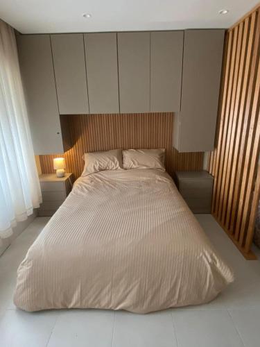 a large bed in a bedroom with two night stands at Rabat Easy Access ll in Rabat