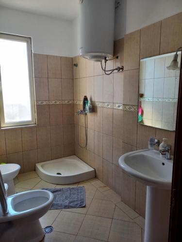 a bathroom with a toilet and a sink at Flodril Appartment in Durrës