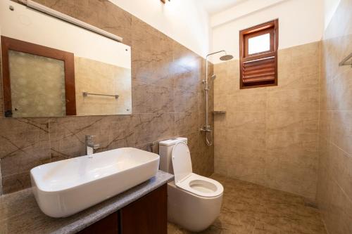 a bathroom with a sink and a toilet at 79 by TerraLume in Nugegoda