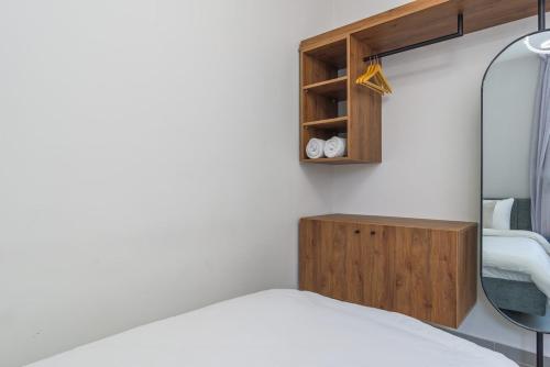 a bedroom with a bed and a mirror at Maison Montagne Mzaar in Kfardebian