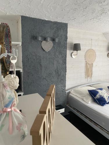 a bedroom with a bed and a table with boxes at Maison de pêcheurs les petits quinquins in Étaples