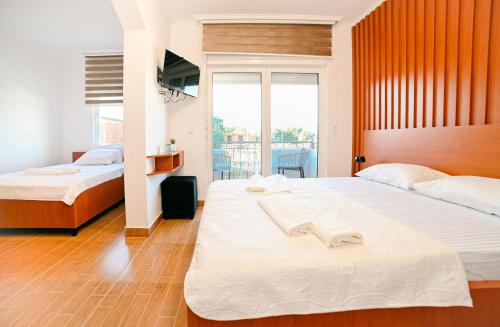 a bedroom with two beds and a window at Lux Ariana in Donji Štoj