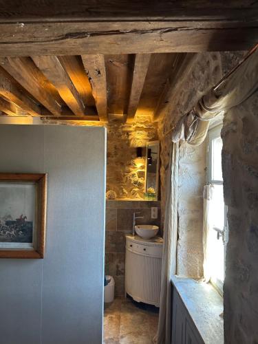 a small bathroom with a sink and a sink at MAISON LA TRANQUILITÉ by Frans & Ricardo in Saint-Didier-sur-Arroux
