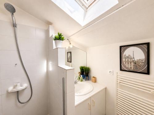 a white bathroom with a shower and a sink at " L'Oratoire Mansardé " Linge fourni - Wifi - TV in Lagardelle-sur-Lèze