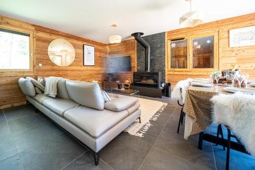 a living room with a couch and a table at Chalet Nanouk - exposé plein sud in La Salle-les-Alpes