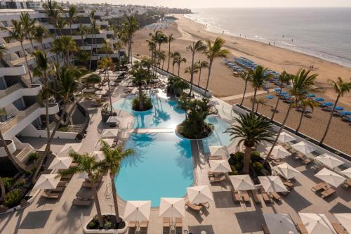 an aerial view of a hotel with a pool and the beach at Plus Fariones Suite Hotel in Puerto del Carmen