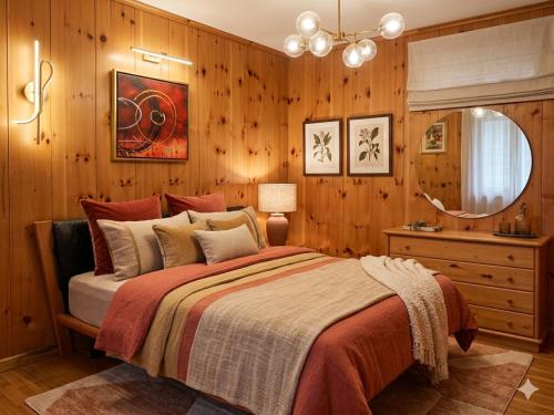 a bedroom with wooden walls and a large bed at Casa Elda in Valdidentro