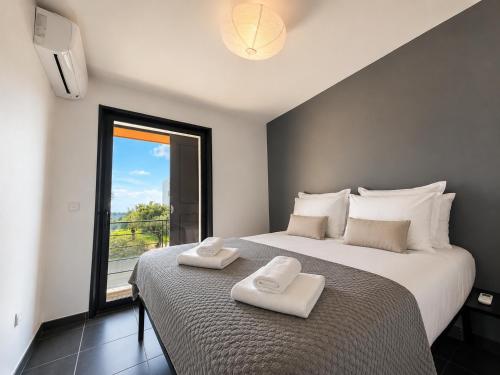 a bedroom with a large bed with two towels on it at Sea Road Perpignan in Perpignan