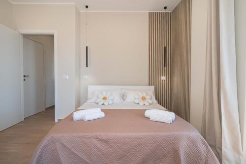 a bedroom with a bed with two white pillows at VJ Apartment in Giardini Naxos