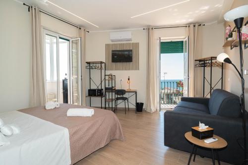 a living room with a bed and a couch at VJ Apartment in Giardini Naxos