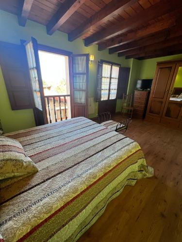 a bedroom with a large bed in a room at Gestiona2R - Casa en Colombres centro in Colombres