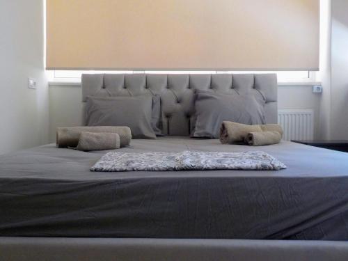 a large bed with a large headboard in a bedroom at GAIA City Studio in Kato Achaia